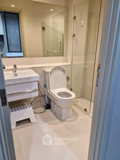 Modern bathroom with sleek fixtures and glass shower enclosure