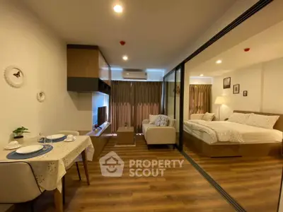 Modern studio apartment with open layout, featuring cozy living area and elegant bedroom.