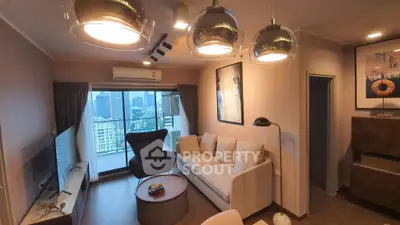 Modern living room with city view, stylish lighting, and cozy seating area in a high-rise apartment.