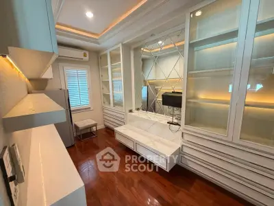 Luxurious living room with elegant built-in cabinets and polished wooden floors.