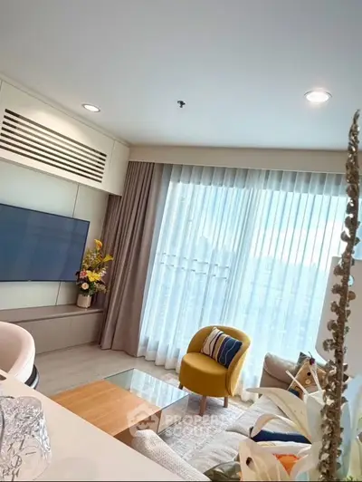 Stylish modern living room with large window and cozy seating area.