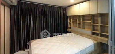 Cozy bedroom with built-in wooden shelves and dark curtains, perfect for modern living.