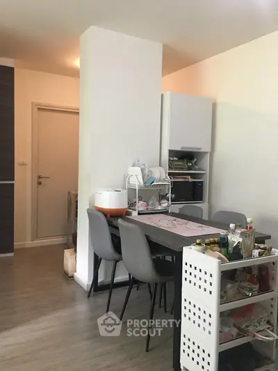 Cozy dining area with modern furniture and organized storage solutions.