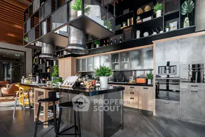 Luxurious modern kitchen with sleek design and high-end appliances, featuring an open layout and stylish decor.