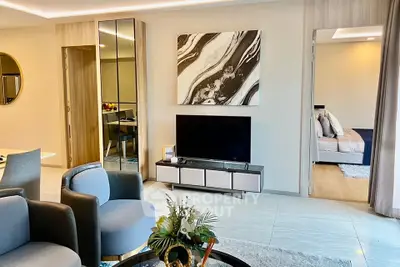 Modern living room with stylish decor and open view into a cozy bedroom