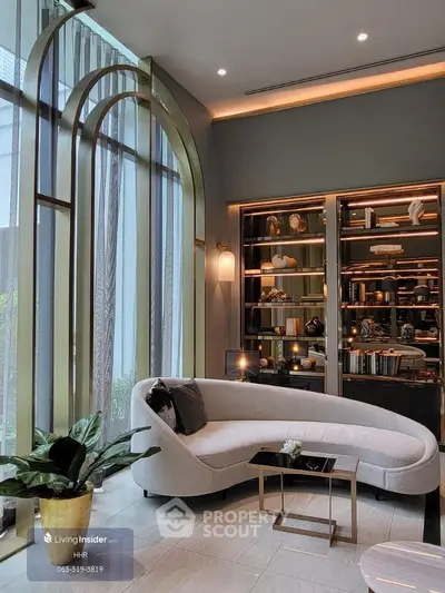 Luxurious living room with elegant curved sofa and floor-to-ceiling windows
