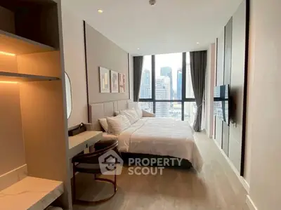 Luxurious bedroom with city view, modern decor, and ample natural light in high-rise apartment.