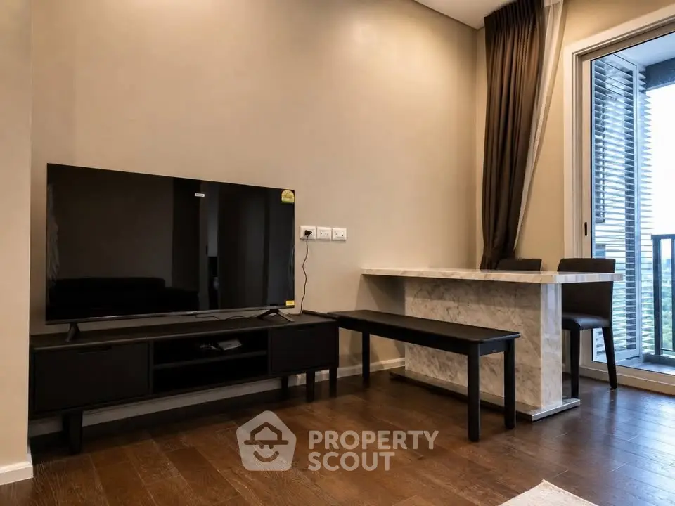 Modern living room with sleek TV setup and stylish balcony view
