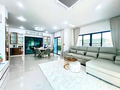 Spacious modern living room with elegant dining area and large windows