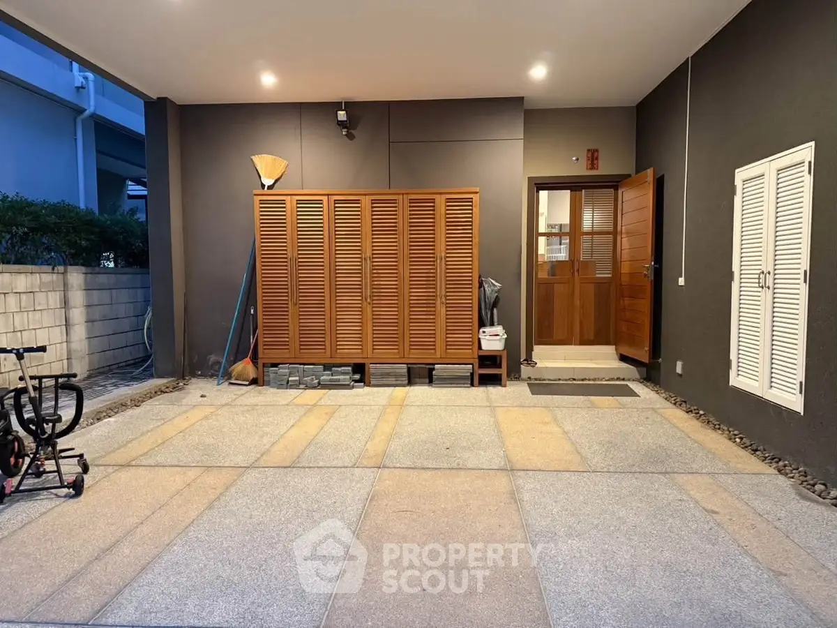 Spacious modern entrance with stylish wooden door and sleek design