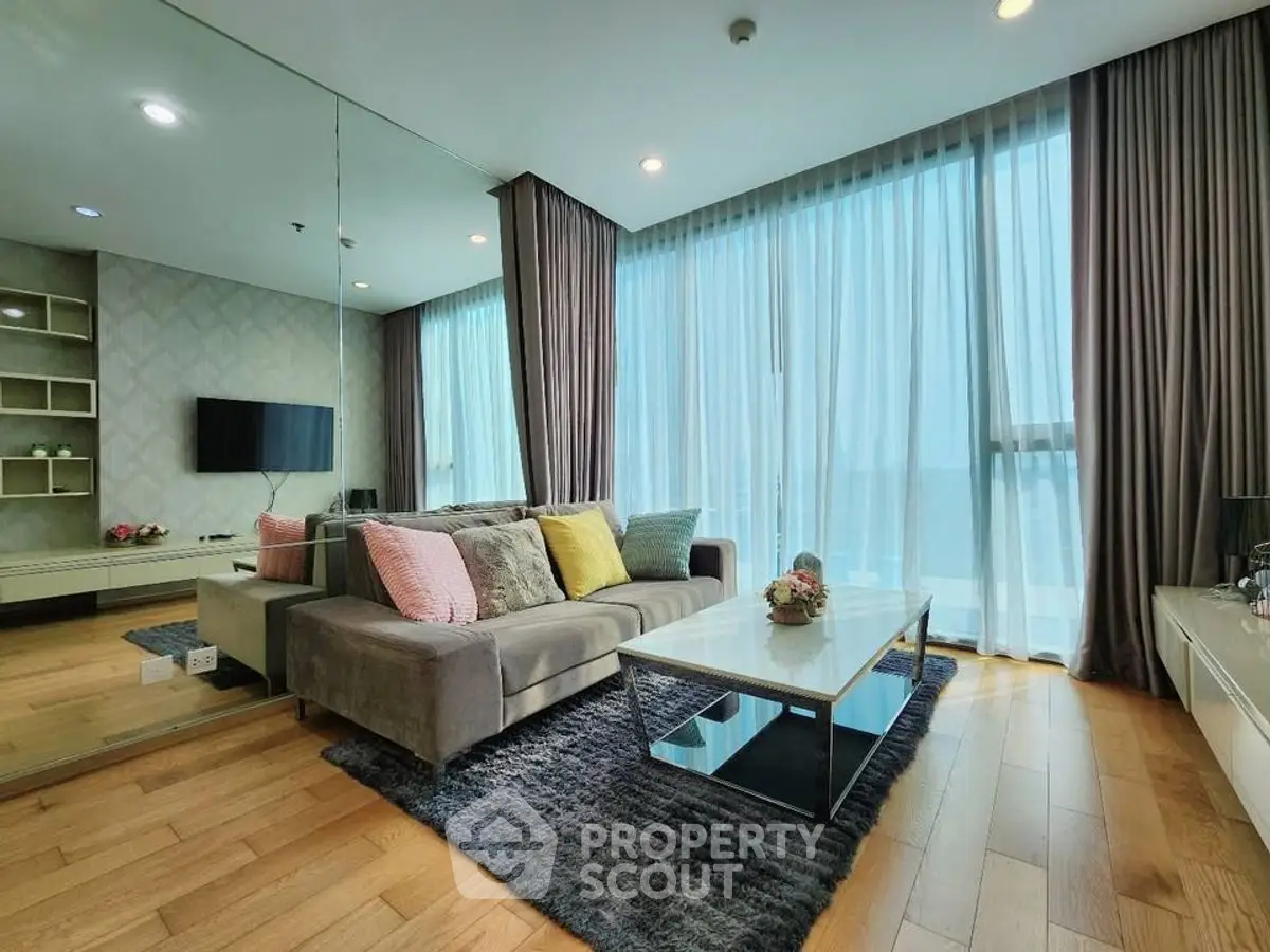 Luxurious modern living room with floor-to-ceiling windows and stylish decor