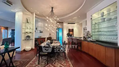 Luxurious dining room with elegant lighting and modern decor in a spacious open layout.