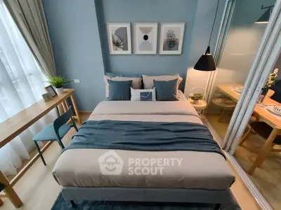 Modern bedroom with stylish decor and natural light in a cozy apartment.