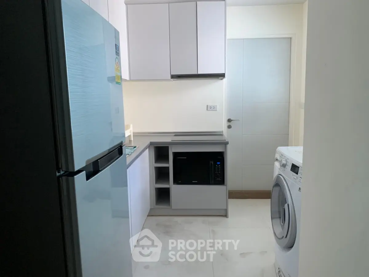 Modern kitchen with sleek appliances and ample storage space
