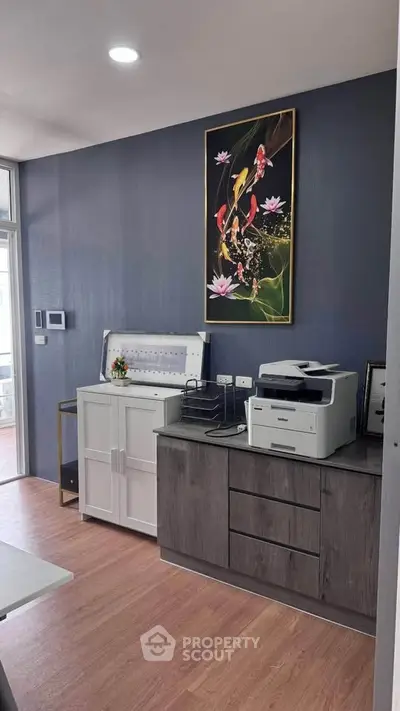 Modern study room with printer and stylish decor in a contemporary home.