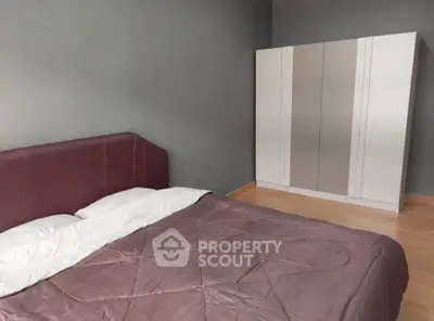 Spacious bedroom with modern wardrobe and cozy bed in minimalist design.