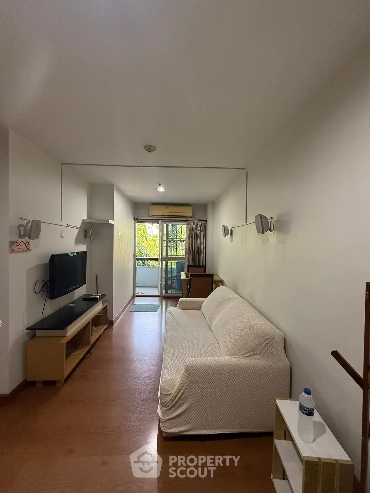 Cozy living room with modern decor and balcony view, perfect for relaxation and entertainment.