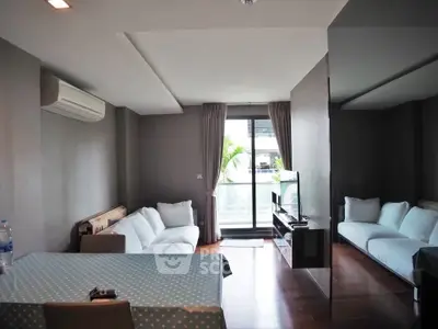 Modern living room with sleek design and large windows offering natural light.