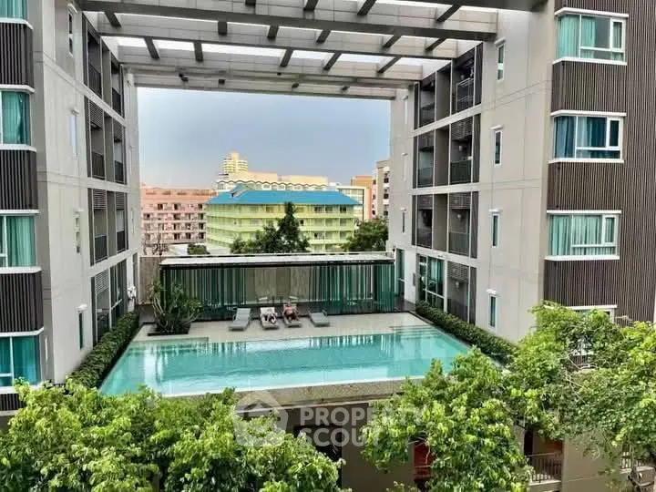 Luxurious apartment complex with rooftop pool and stunning city view.