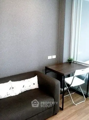 Cozy modern living room with sleek sofa and compact workspace