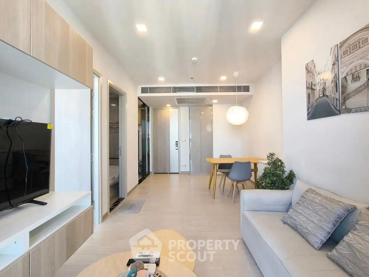 Modern living room with stylish decor and open layout, featuring a cozy sofa and contemporary furniture.