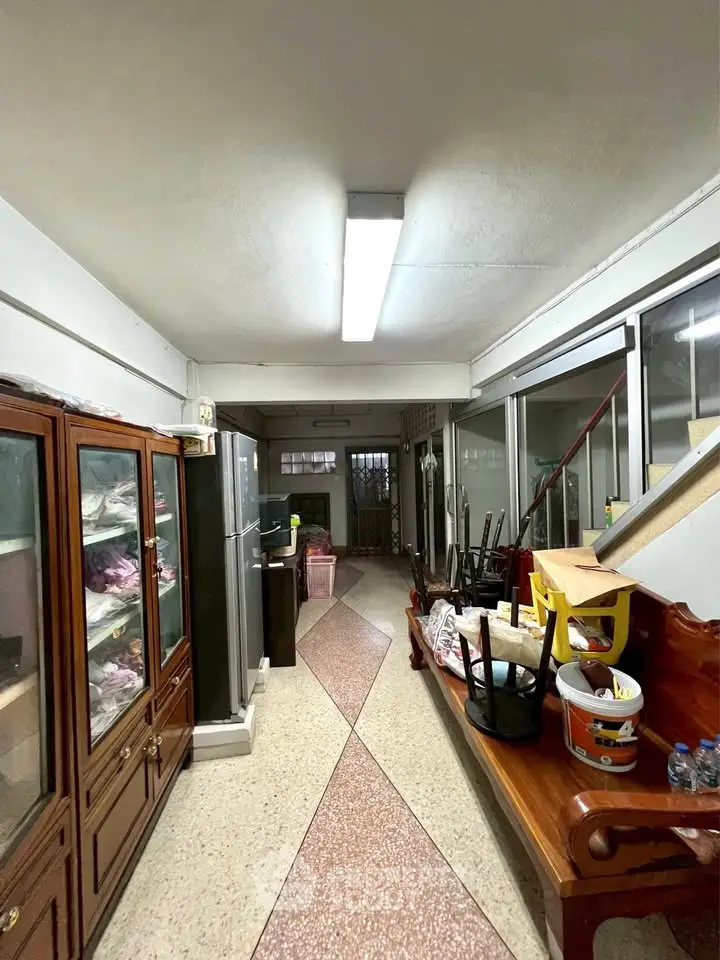 Spacious interior hallway with storage and seating, featuring a unique floor design.