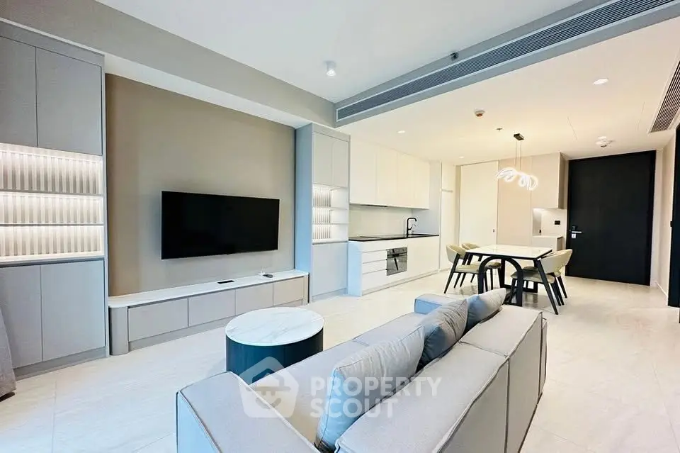 Modern open-plan living room and kitchen with sleek design and neutral tones