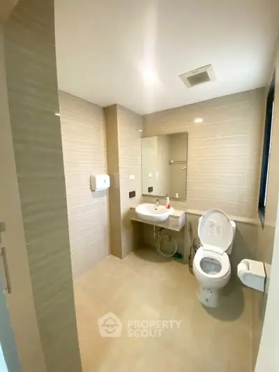Spacious modern bathroom with sleek fixtures and neutral tones, perfect for a contemporary home.