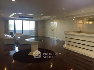 Spacious living room with elegant white furniture and polished wooden floors