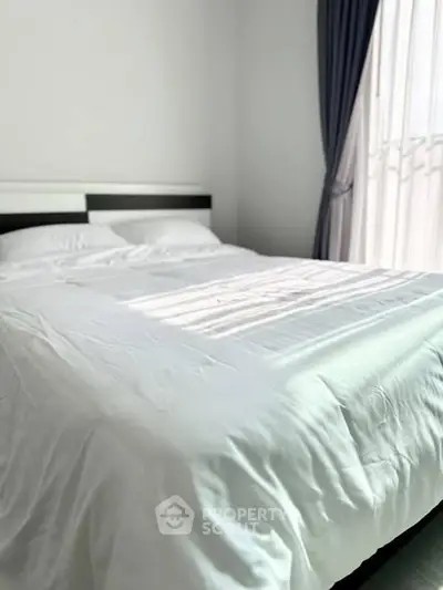 Cozy bedroom with elegant curtains and a comfortable bed, perfect for relaxation.