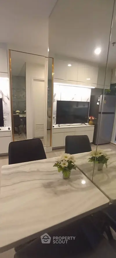 Modern living room with sleek TV unit and marble dining table