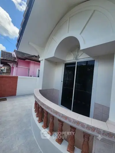 Charming balcony with decorative railing and tiled floor in a residential property.
