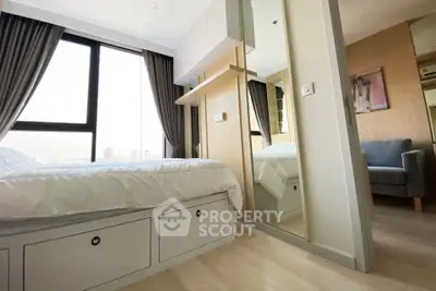 Modern bedroom with large window and stylish decor in urban apartment