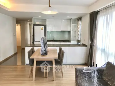 Modern open-plan kitchen and dining area with sleek design and natural light