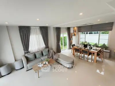 Spacious modern living room with elegant dining area and garden view, perfect for family gatherings.