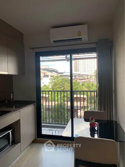 Modern kitchen with balcony view in urban apartment