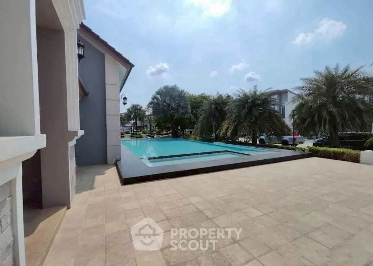 Luxurious property with stunning pool and lush greenery, perfect for relaxation and entertainment.