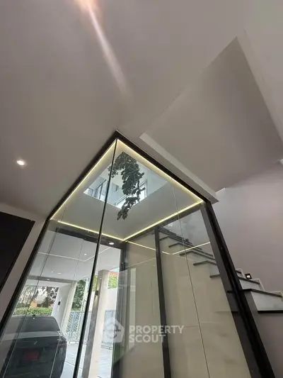 Modern architectural entrance with glass walls and sleek design