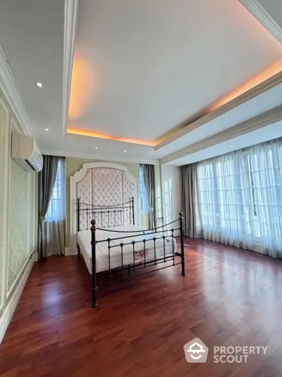 Luxurious bedroom with elegant design and large windows for natural light.