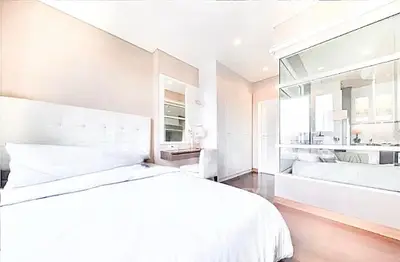 Luxurious bedroom with modern decor and large mirror