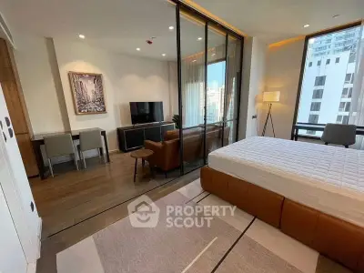 Modern studio apartment with open layout, featuring a cozy living area and stylish bedroom.
