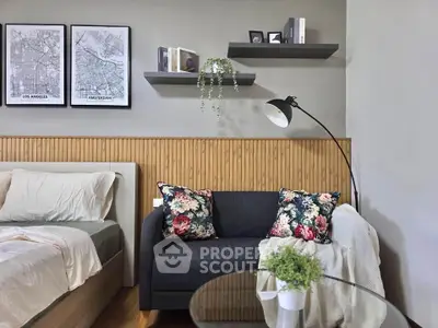 Chic bedroom with cozy seating area, stylish decor, and modern lighting, perfect for relaxation and comfort.