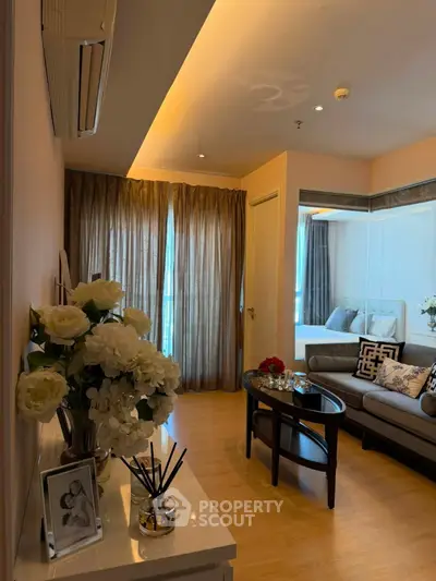Elegant living room with cozy seating and stylish decor, featuring soft lighting and a warm ambiance.