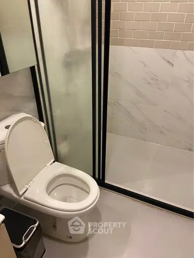 Modern bathroom with sleek glass shower and elegant tile design