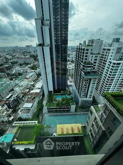 Stunning high-rise cityscape view with luxurious rooftop pool and modern architecture.