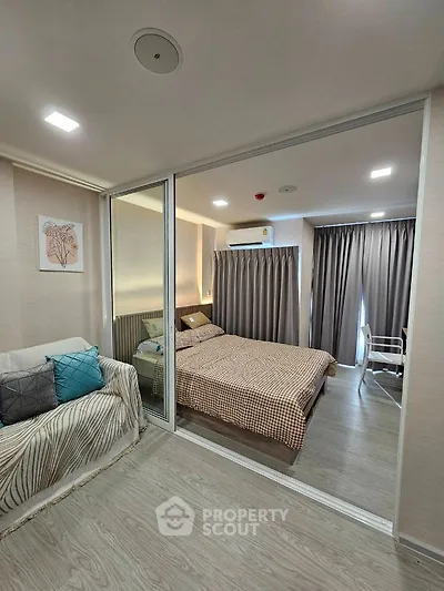 Modern bedroom with stylish decor and cozy ambiance in a contemporary apartment.