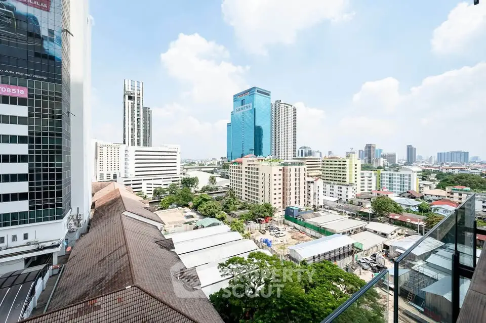 Stunning cityscape view from a high-rise balcony showcasing urban skyline and vibrant city life.