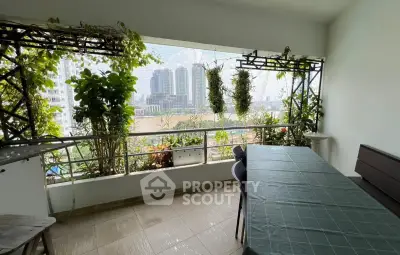 Spacious balcony with lush greenery and stunning city view, perfect for relaxation and entertaining.