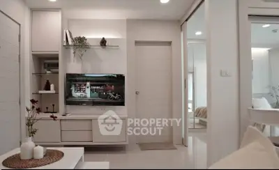 Modern living room with sleek white furniture and built-in TV unit