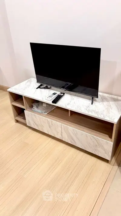 Modern living room with sleek TV stand and flat-screen television